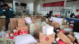 Staff members are sorting express deliveries in Enshi, China
