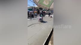 Bungling motorcyclist rides through freshly laid cement
