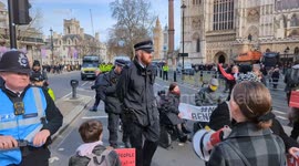 Police move in to disperse the London day of action protest against proposed UK benefit reforms
