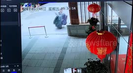 Woman's hilarious fall after tripping on cushions while entering building in China