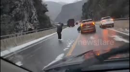 Slippery struggle: Chinese man navigates icy terrain on road