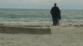 Hilarious moment pooping dog interrupts romantic beach wedding proposal