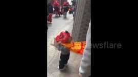 One-Year-Old Interacts With Lion Dance Troupe in Guangdong, China