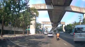 Motorcycle rider catches falling helmet with his foot