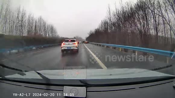 Driver navigates through still cars after possible accident in China