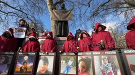 Iranian Women dressed as Handmaids on International Women's Day, London, UK.