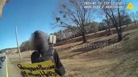 Police Officer buys goods for the cold weather for a homeless man in Atlanta, GA, USA