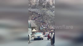 Remote cliffside village transforms into tourist hotspot, drawing in crowds and long queues