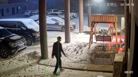 Man struggles with slippery surface while cleaning snow in Henan, China