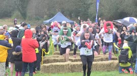 UK Wife Carrying Race 2024: Husbands carry wives through course as spectators splash them with water