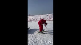 Skier and snowboarder form human chair to tackle slopes