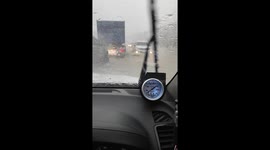 Tropical storm floods road leaving scooter rider stranded in deluge