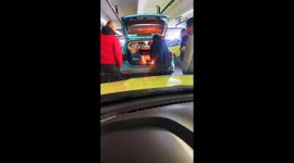 Chinese Family Prepares Food with Open Flame in Car Trunk