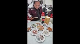 Chinese village residents brave snowy weather for unforgettable family meal