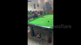 A player tears up a billiard table in a fit of anger in Henan, China