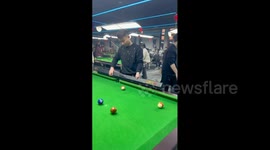 Man Uses Branch as Cue Stick in Billiards Game in Fuyang, China