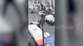 Men take shirts off for punch-up amid busy traffic in lawless London