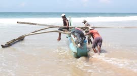 Pushing a boat out in big waves