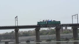 Electrician working on top of train in Ahmedabad 