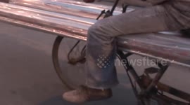 Man rides electric tricycle without feet on pedals