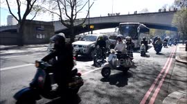 Dozens of scooter riders driver through London