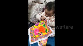 Little girl shows strong interests in learning embroidering in Zunyi, China