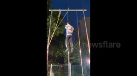 Man effortlessly and skillfully climbs tall pole