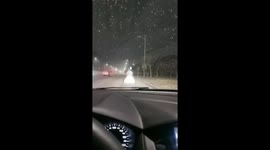Bride in Wedding Dress Walks Alone on Snowy Roadside at Night in China