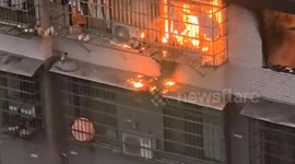 Cat escapes through window as fire erupts in Chinese residential building