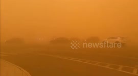 Cars struggle to move as severe sandstorm turns sky orange