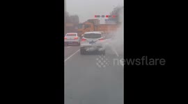 SUV on the highway emitting thick smoke from two exhaust pipes in Weifang, China