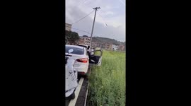 Chinese Woman Falls into Pit While Exiting Car
