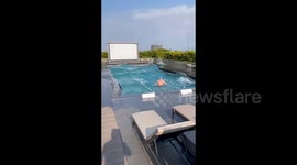 Terrified swimmer sways in water as Taiwan  earthquake rattles rooftop pool at hotel