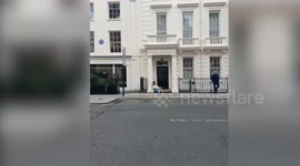 Adam Sandler slumped on pavement outside Claridge's hotel in Mayfair