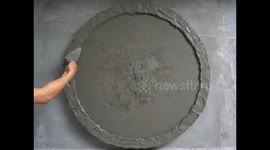 Artist creates cement moon with warm glow