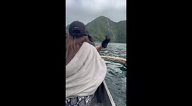 Woman almost falls from bamboo raft into lake