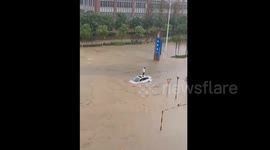 Man get stranded on car roof as record-breaking rainfall hits southern China