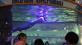 A mermaid and merman perform in Chiang Mai during Sonkran water festival