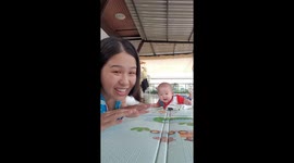 Mother makes faces at camera and baby copies her
