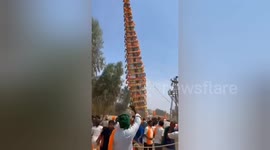 Moment 120-foot-tall monument topples over during Hindu procession in south India