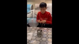 Chinese boy crafts fan with cocoons as affectionate gift for mother