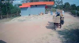 Delivery man's overloaded motorcycle topples over while he retrieve fallen parcel