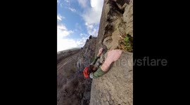 Moment climber disturbs hidden owl - but manages to hang on