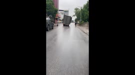 A truck with a leaning container moving on the street caught on cam