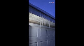 Considerate man takes time out of day to smash irky icicles