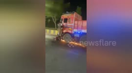 Man clings onto truck racing along highway with bike stuck under wheels in India