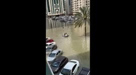 Locals raft through submerged streets on boat as record-breaking rainfall hits UAE