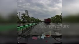 Trucker steps onto waterlogged motorway to catch fish from deluge