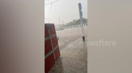 Man battles through storm to retrieve rubbish bin