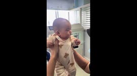 Three-month-old baby stays calm during vaccine appointment